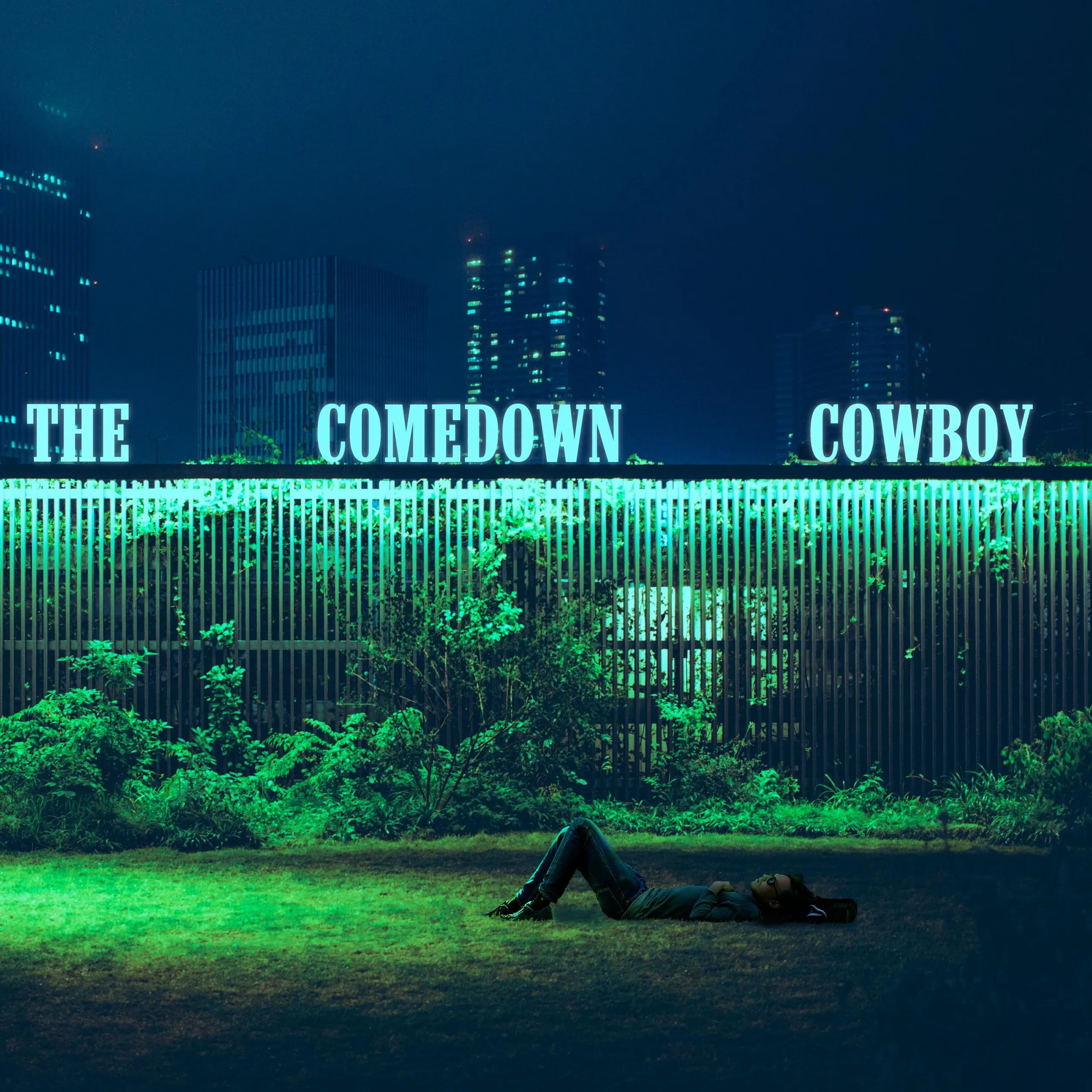 Man lying on grass blue green color scheme.