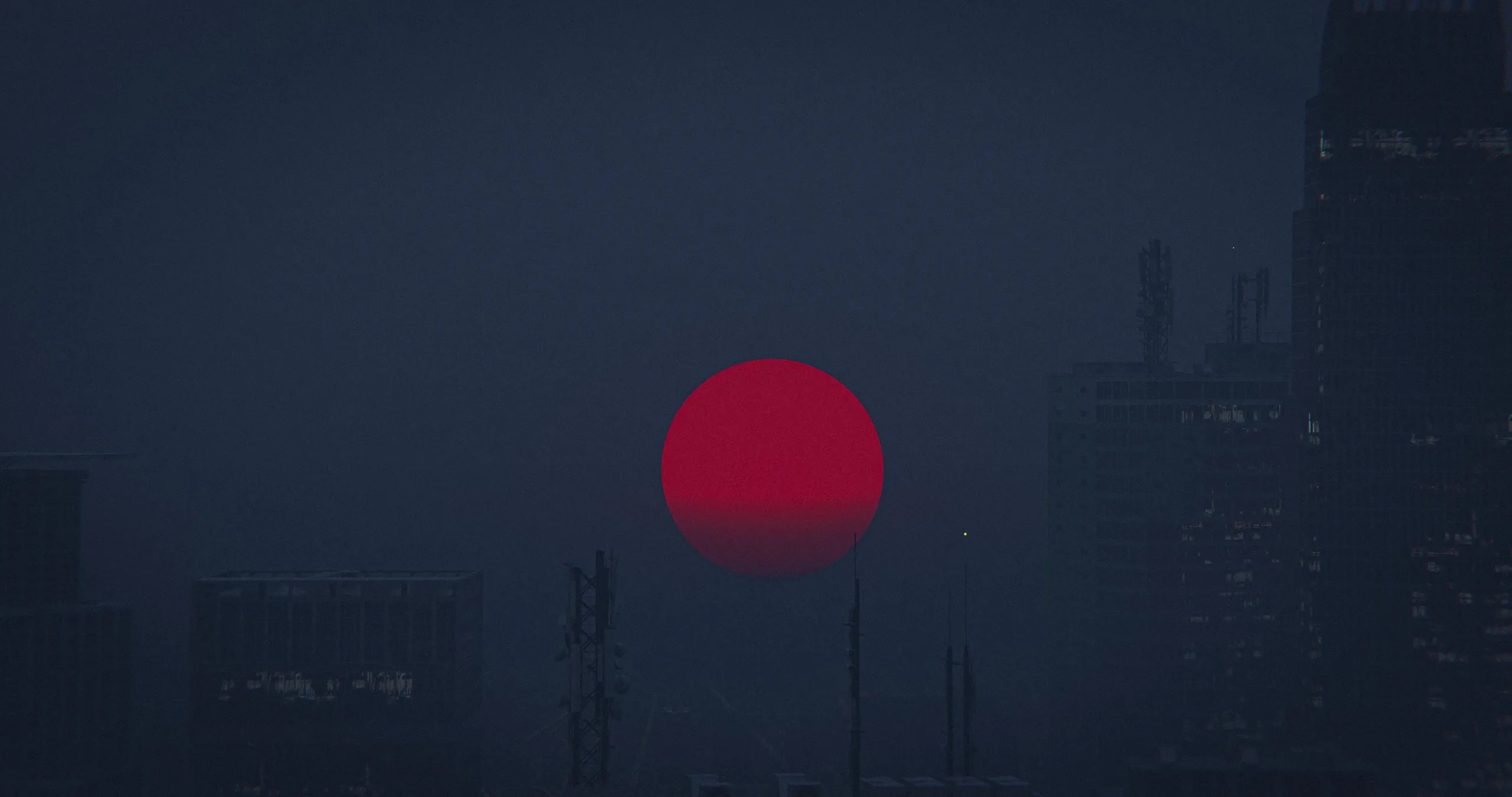 Red sunset over city scape.
